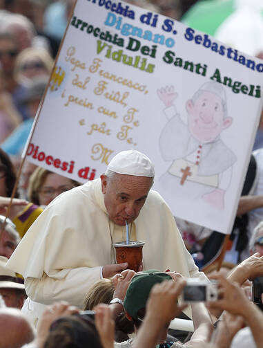 My Mate: Pope Francis drinks mate, the traditional Argentine herbal tea, as he arrives to lead his general audience in St. Peter's Square at the Vatican Aug. 27. The tea was presented by someone in the crowd. (CNS photo/Paul Haring)