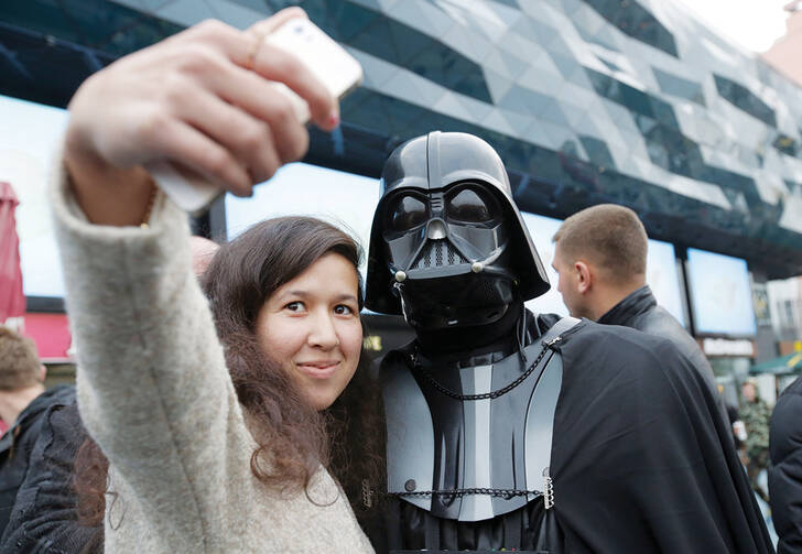 STAR WARS SELFIE. Ukrainian woman poses with a person dressed as Darth Vader.