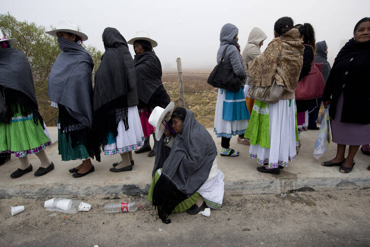 Women wait to enter to the site where Pope Francis will celebrate Mass during his one-day visit in San Cristobal de las Casas, Mexico, early Monday, Feb. 15, 2016. (AP Photo/Moises Castillo)