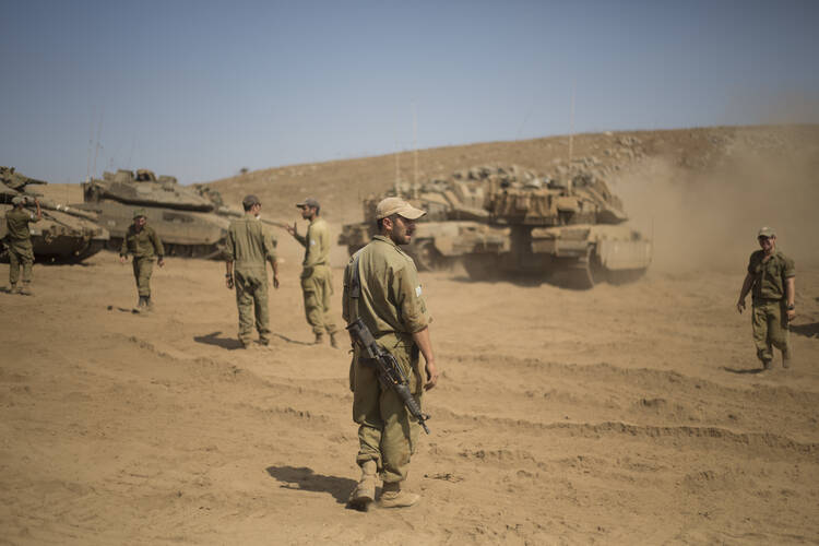 Israeli soldiers gather next to tanks during training in the Israeli-controlled Golan Heights, near the border with Syria, on Sept. 13. (AP Photo/Ariel Schalit)