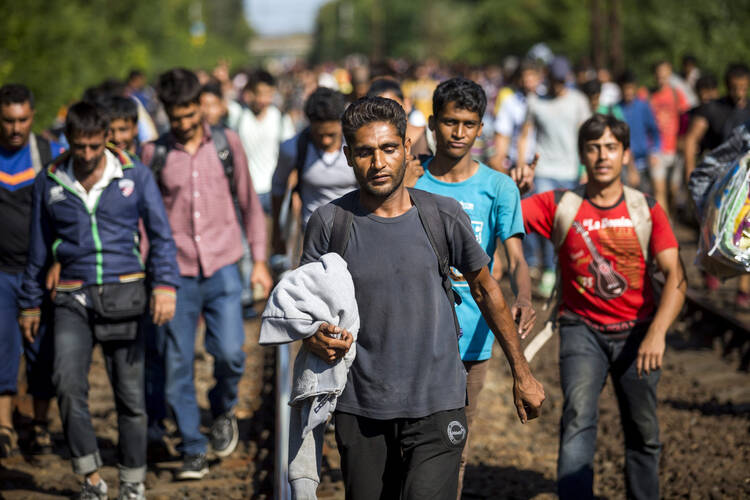 Migrants walk on the railway tracks in Bicske, Hungary, near the Austrian border Sept. 4.