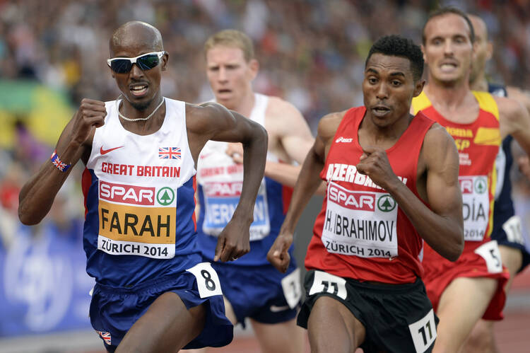 Mo Farah of Great Britain, left, competes in the men's 5,000- meter final during the European Athletics Championships in Zurich, Switzerland Aug. 17, 2014. (CNS photo/Jean-Christophe Bott, EPA)