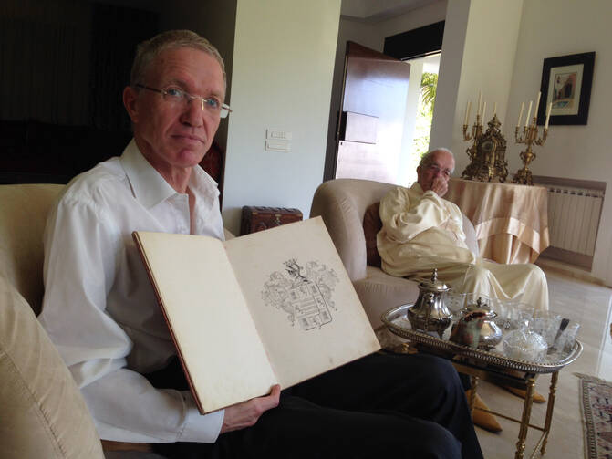 Hassan Bargach at his home in Rabat, Morocco on June 4, 2014, showing the book presented to his family by the Spanish government tracing its roots to the Iberian town of Hornachos. Photo by Gil Shefler.