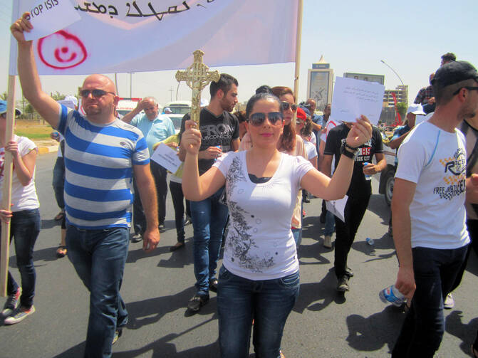 Christian refugees march against persecution by Islamic State fighters outside the U.N. compound near the airport in Irbil, Iraq, July 24. Christians braved temperatures as high as 122 degrees Fahrenheit to make their voices heard. 