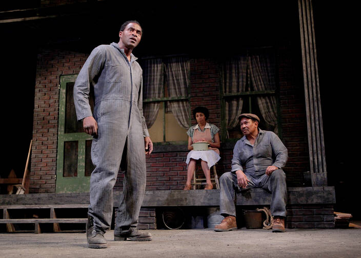 Carl Lumbly as Troy Maxson (foreground), with Margo Hall as Rose and Steven Anthony Jones as Jim Bono (background), in August Wilson's Fences (Photo: Ed Smith).