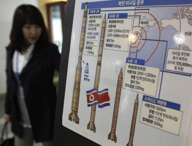 A Japanese tourist views a board showing details of North Korean missiles at an observation post near the demilitarized zone near Seoul, South Korea, in 2009. (CNS photo/Lee Jae-Won, Reuters)