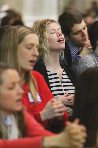 A HOMECOMING. People sing during a Mass for young adults at St. Patrick’s Cathedral in New York, Dec. 10.
