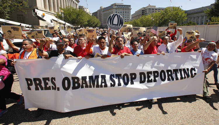 Protesters carry banner in front of White House during immigration march and rally