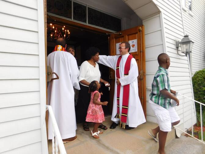 The Rev. Kazimierz Bem greets worshippers leaving First Church in Marlborough, Mass., following an ecumenical prayer service on June 3 (Photo: First Church/Barbara Parente).