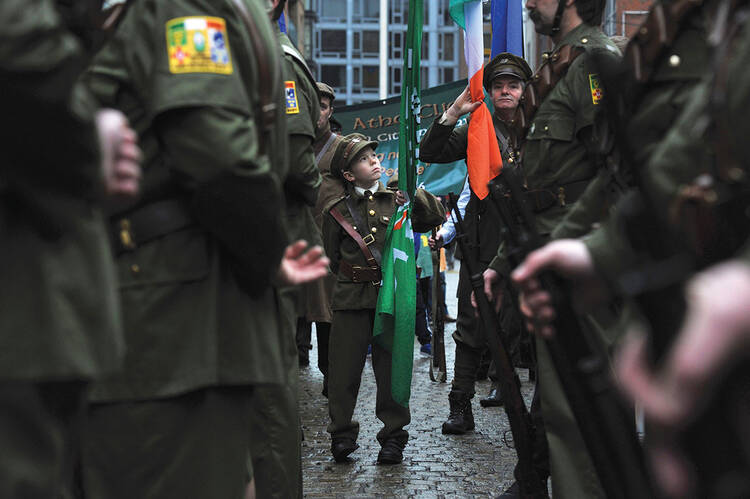 INNOCENCE AND EXPERIENCE. Brian Kiernan, 11, attends a Sinn Fein rally with members of the Finglas 1916 Commemoration group in Dublin on Jan. 31. 