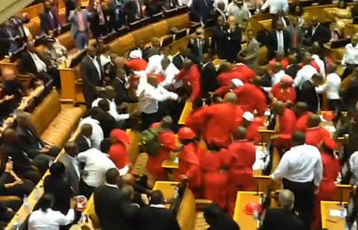 Members of the Economic Freedom Fighters being removed from the South African Parliament. 
