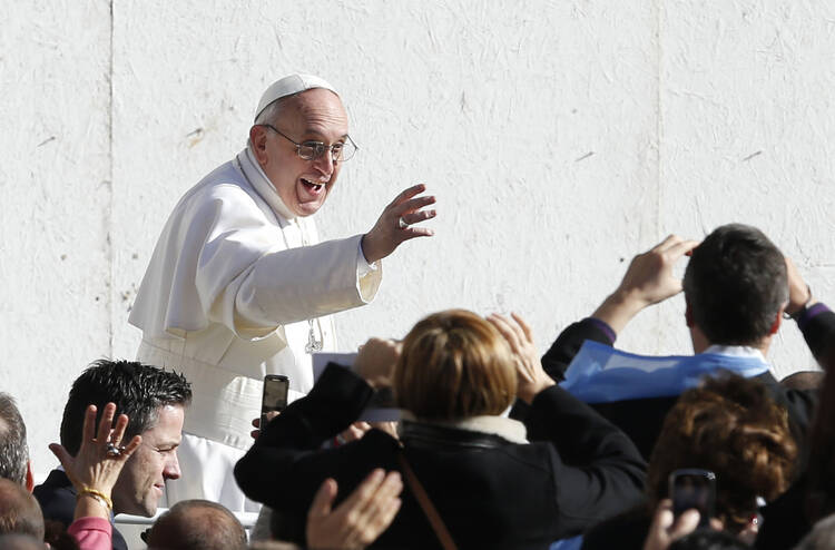 Pope Francis greets people before celebrating inaugural Mass in St. Peter's Square at Vatican. CNS Photo/Paul Haring
