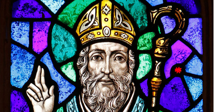 St. Patrick is depicted in a stained-glass window at St. Aloysius Church in Great Neck, N.Y. Archbishop Eamon Martin of Armagh, Northern Ireland, said that "as Irish people, we cannot think of St. Patrick without acknowledging the enormous humanitarian and pastoral challenges facing growing numbers of people who find themselves displaced and without status in our world." (CNS photo/Gregory A. Shemitz)
