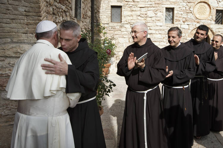 U.S. Franciscan Father Michael Perry, minister-general of the Order of Friars Minor, embraces Pope Francis during his visit to the hermitage and cell of St. Francis in Assisi, Italy, in October 2013 (CNS photo/Paul Haring) 