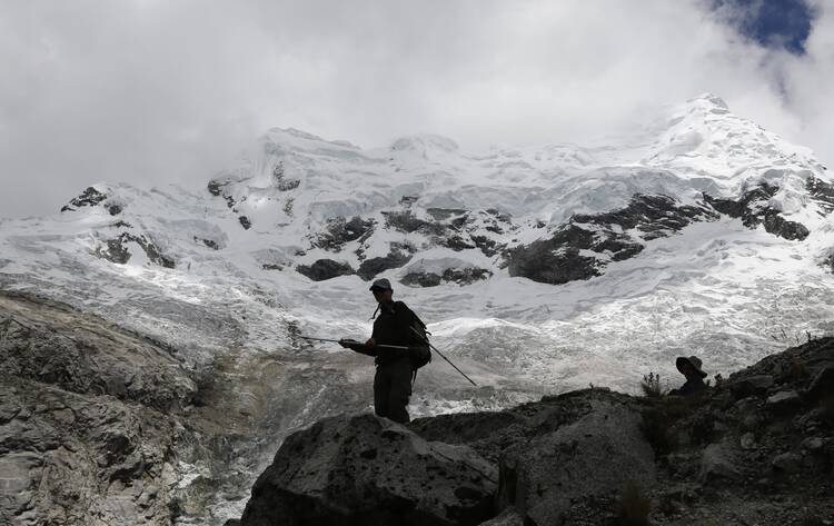People walk near the Hualcan Glacier in the Ancash region of Peru Nov. 29. Peru is hosting the annual U.N. Climate Change Conference (COP20) in Lima Dec. 1-12. (CNS photo/ Mariana Bazo, Reuters)