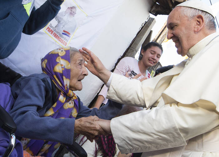 Pope Francis greets an elderly woman as he meets with people of Banado Norte, a poor neighborhood in Asuncion, Paraguay, July 12 (CNS photo/Paul Haring). 