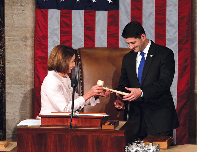 U.S. House Speaker Paul Ryan receives the gavel from House Democratic leader Nancy Pelosi on Jan. 3. (Jonathan Ernst/Reuters)