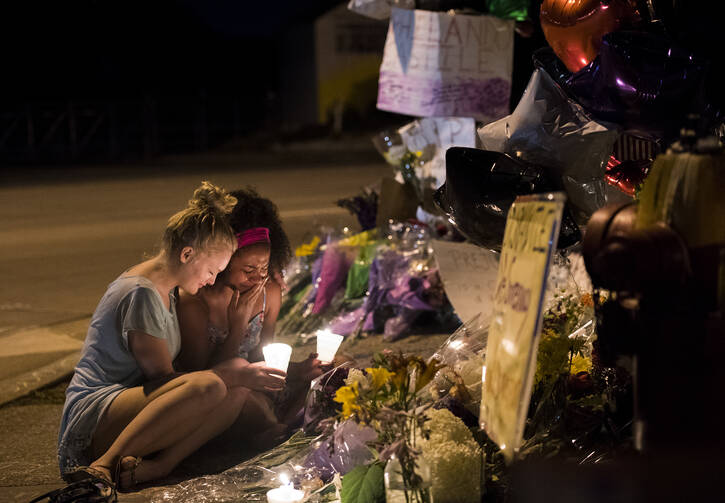 Mourners gather on the roadside where Philando Castile, an African-American, was killed by police in St. Paul, Minn., during a traffic stop on July 6. (Isaac Hale/Star Tribune via AP)