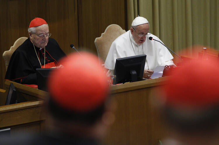 Pope Francis speaks during a meeting with cardinals and cardinals-designate in the synod hall at the Vatican Feb. 12. At left is Cardinal Angelo Sodano, dean of the College of Cardinals.