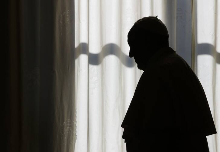 Pope Francis is silhouetted after his private audience with President of Sierra Leone Ernest Bai Koroma, at the Vatican, Saturday, Nov. 11, 2017. (Tony Gentile/Pool Photo via AP)