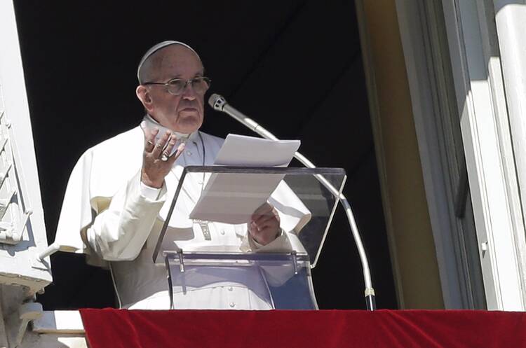 Pope Francis speaks as he leads the Angelus from the window of his studio overlooking St. Peter's Square at the Vatican Jan. 24 (CNS photo/Max Rossi, Reuters).