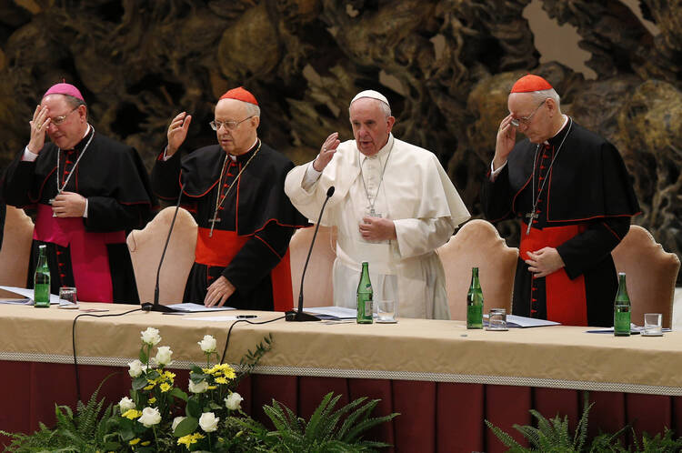 Pope Francis delivers his blessing during an event marking the 50th anniversary of the Synod of Bishops in Paul VI hall at the Vatican, Oct. 17 (CNS Photo / Paul Haring).