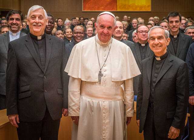 Arturo Sosa, S.J., left, the new superior general of the Jesuits, and Orlando Torres, S.J., stand with Pope Francis at a meeting of GC 36 on Oct. 24 (photo courtesy GC 36).