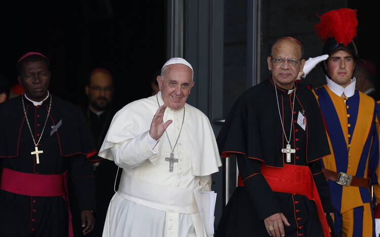 Pope Francis walks next to Indian Cardinal Oswald Gracias as he leaves the morning session of the extraordinary Synod of Bishops on the family at the Vatican, Oct. 9, 2014 (CNS photo/Paul Haring).