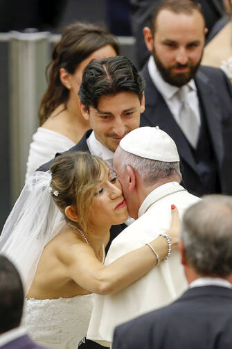 Pope Francis greets newly married couples during his weekly audience in Paul VI hall at the Vatican Aug. 5. (CNS photo/Giampiero Sposito, Reuters) 