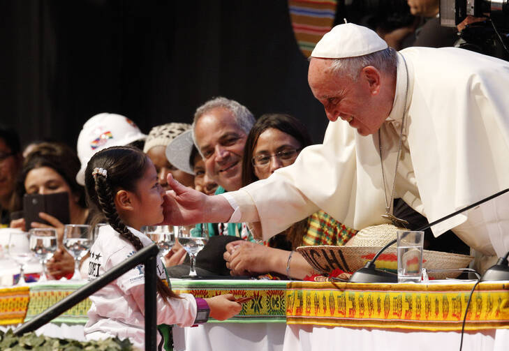 Pope Francis greets a young girl as he participates in the second World Meeting of Popular Movements in Santa Cruz, Bolivia, July 9 (CNS photo/Paul Haring).