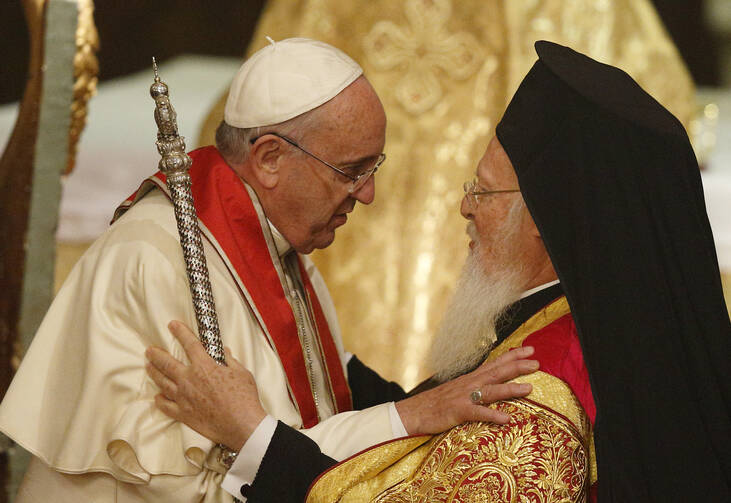 Pope Francis and Ecumenical Patriarch Bartholomew of Constantinople embrace during a prayer service in the patriarchal Church of St. George in Istanbul Nov. 29. (CNS photo/Paul Haring)
