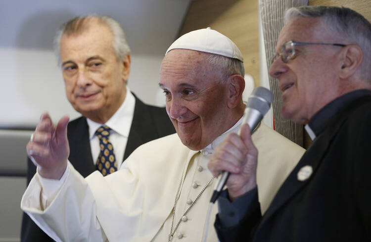 Pope Francis greets journalists aboard his flight from Rome to Havana, Sept. 19 (CNS photo/Paul Haring).