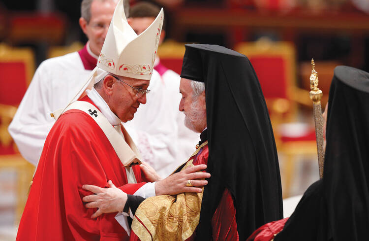 A BROTHER'S EMBRACE. Pope Francis greets Metropolitan John of Pergamon, head of the Orthodox delegation from the Ecumenical Patriarchate of Constantinople, at the Vatican on June 29. (CNS photo/Paul Haring) 