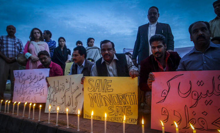 Christians light candles to protest killing of couple accused of blasphemy in Pakistan (CNS photo/Sohail Shahzad EPA)