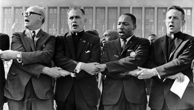 Holy Cross Father Theodore Hesburgh, second from left, and the Rev. Martin Luther King Jr. participate in a June 21, 1964, rally at Chicago's Soldier Field. (CNS photo/National Portrait Gallery) (Oct. 10, 2007)