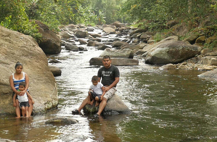 Water of Life. Kevin Ramíez and his family on the Río Listón near Quimistán, Honduras.