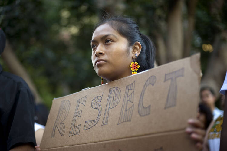 Woman in San Diego at a vigil and rally last year to show support for undocumented Central American minors flooding across the U.S.-Mexico border.