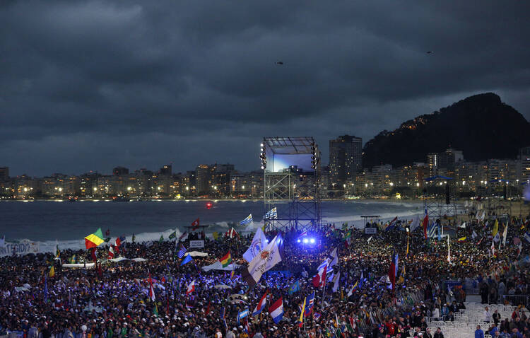 Pilgrims wait for arrival of pope at World Youth Day welcome ceremony on Copacabana beach in Rio de Janeiro (CNS Photo/Paul Haring)