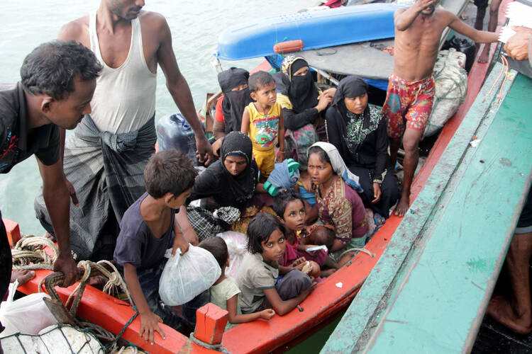 Refugees from Myanmar and Bangladesh are seen in their boat before their rescue by fisherman in Julok, Indonesia, May 20. (CNS photo/Stringer, EPA)