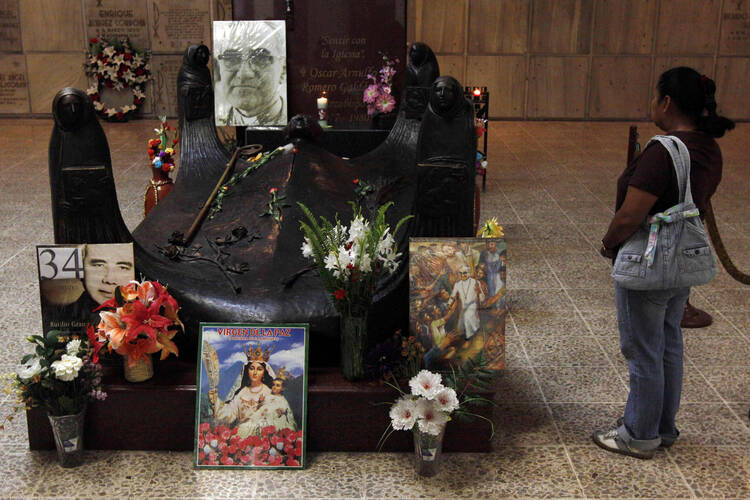 A tourist visits the tomb of Archbishop Oscar Romero in San Salvador.