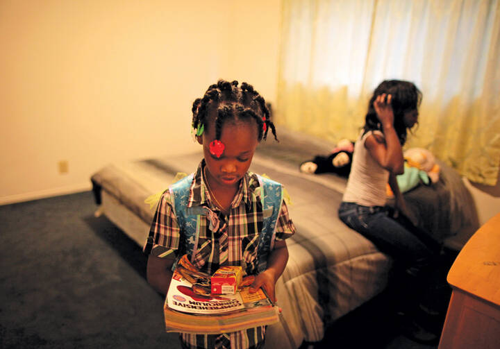 KEEPING UP? Jayla, left, prepares for her weekly Schools on Wheels tutoring session at a homeless shelter in Los Angeles, Calif.