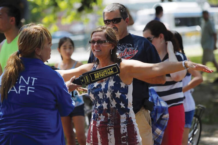 INDEPENDENCE DAY? Spectators are checked by security in Boston, Mass., July 4, 2013. 