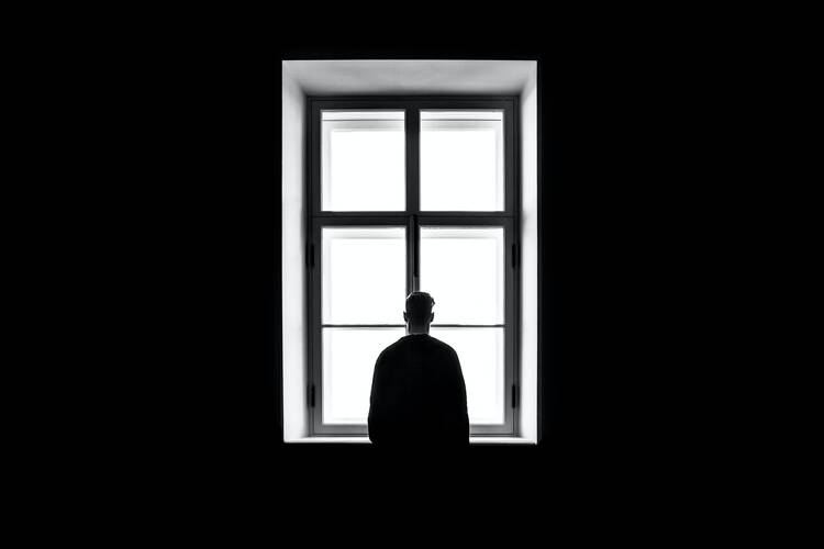 Man standing in front of the window