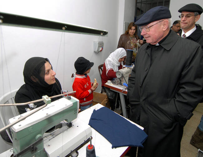 Bishop William S. Skylstad of Spokane, Wash., visits a women's sewing factory in the Dehiyshe refugee camp near Bethlehem in the West Bank on Jan. 12, 2007. (CNS photo/Debbie Hill)