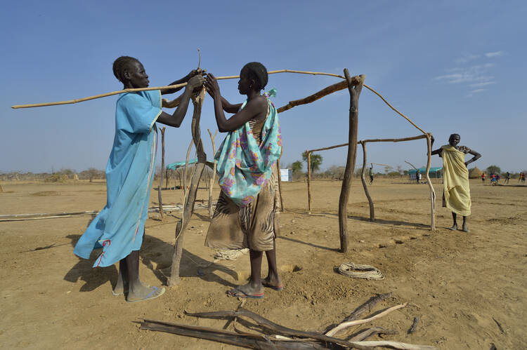 Women construct a shelter March 19 in a camp for internally displaced persons camp in Turalei, South Sudan.