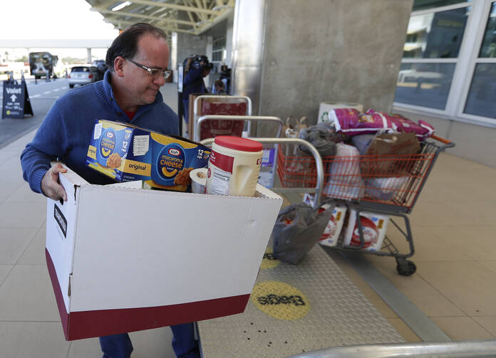 A food and supply donation for unpaid but working Transportation Safety Administration agents lands at Orlando International Airport on Jan. 16. (AP Photo/John Raoux)