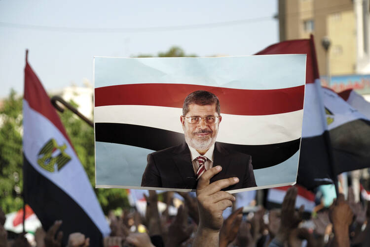 NOT FORGOTTEN: A protester raises a sign in support of deposed president Mohamed Morsi on June 21, 2013.