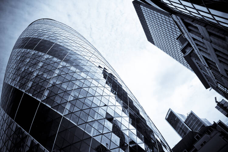 LONDON - The modern glass buildings of the Swiss Re Gherkin on July 28, 2007, in London, England. This tower is 180 meters tall and stands in the City of London Financial District. Copyright: donsimon