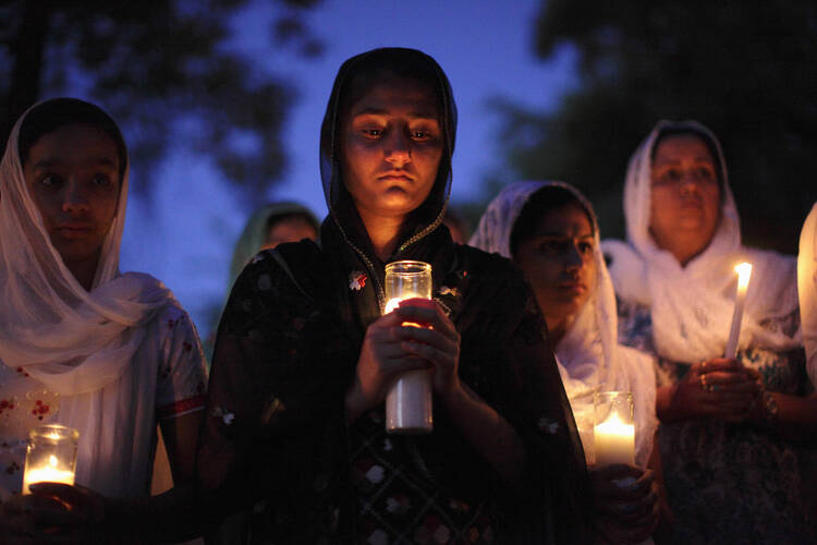 Remembering shooting victims at a candlelight vigil in 2012 at a Sikh temple in Wisconsin
