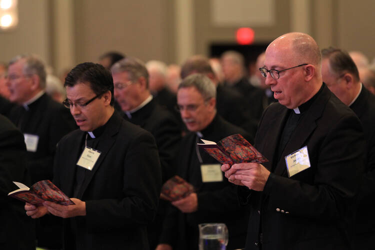 Bishops sing June 11 during the opening prayer of the annual spring meeting of the U .S. Conference of Catholic Bishops in New Orleans. 
